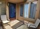 Welcoming front entrance featuring a patio area with chairs and a view through the glass front door at 3636 Woodglen Way, Anderson, IN 46011