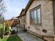 Charming brick home with a small patio and a landscaped pathway leading to the backyard at 3636 Woodglen Way, Anderson, IN 46011