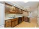 Functional kitchen featuring wooden cabinets, stainless steel sink, and modern appliances at 3636 Woodglen Way, Anderson, IN 46011