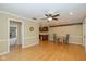 Spacious living room with hardwood floors, ceiling fan, and decorative molding around the ceiling at 3636 Woodglen Way, Anderson, IN 46011