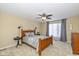Well-lit main bedroom featuring a ceiling fan, large window, and warm neutral color walls at 3636 Woodglen Way, Anderson, IN 46011