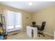 Bright office space with a modern desk setup and a large window for natural light at 3636 Woodglen Way, Anderson, IN 46011
