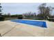 Outdoor pool is enclosed with a neutral concrete surround and is adjacent to a tennis court at 3636 Woodglen Way, Anderson, IN 46011