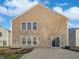 Exterior rear view of a two-story home with vinyl siding, a patio, and a partially grassy yard at 4140 Congaree Dr, Indianapolis, IN 46235