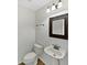 Well-lit half bathroom featuring a decorative mirror and pedestal sink at 4140 Congaree Dr, Indianapolis, IN 46235