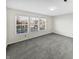 Bedroom featuring carpeted floors and three large windows for natural light at 4140 Congaree Dr, Indianapolis, IN 46235