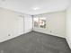 Neutral bedroom with carpeted floors, two large windows, and a closet at 4140 Congaree Dr, Indianapolis, IN 46235
