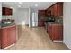 Open kitchen with stainless steel appliances and cherry wood cabinets at 4140 Congaree Dr, Indianapolis, IN 46235