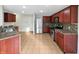 Beautiful kitchen with cherry wood cabinets, stainless steel appliances, and decorative tile backsplash at 4140 Congaree Dr, Indianapolis, IN 46235