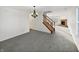 Inviting living room with a staircase, and an open floor plan leading to a cozy fireplace at 4140 Congaree Dr, Indianapolis, IN 46235