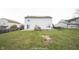 Exterior view of a home showing the backyard with a grassy lawn, trees, and fencing at 436 N Shore Ct, Franklin, IN 46131