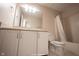 Clean bathroom featuring a toilet, vanity with storage, a mirror with lighting, and a bathtub with shower at 436 N Shore Ct, Franklin, IN 46131