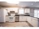 Well-lit kitchen featuring white appliances, white cabinets and stainless steel dishwasher at 436 N Shore Ct, Franklin, IN 46131