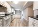 Well-lit kitchen features white cabinets, stainless steel appliances, and dark countertops at 436 N Shore Ct, Franklin, IN 46131