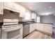 Bright kitchen with white cabinets, stainless steel dishwasher and tile flooring at 436 N Shore Ct, Franklin, IN 46131