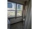 Outdated bathroom with a toilet, two windows, and a shower curtain in a home that needs repairs at 439 N Colorado Ave, Indianapolis, IN 46201