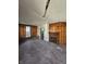 Living room featuring hardwood floors, wood paneled walls, and a fireplace at 439 N Colorado Ave, Indianapolis, IN 46201