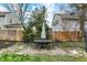 Outdoor patio area with a table and chairs, complemented by mature trees and fenced yard at 4517 Central Ave, Indianapolis, IN 46205