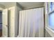 Clean bathroom view features a shower with a white curtain and storage solutions at 4517 Central Ave, Indianapolis, IN 46205