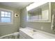 Well-lit bathroom featuring a vanity, large mirror, and classic black and white tile at 4517 Central Ave, Indianapolis, IN 46205