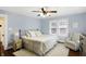 Light-filled bedroom with ceiling fan, neutral walls, and windows overlooking the backyard at 4517 Central Ave, Indianapolis, IN 46205