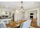 Open-concept dining room leading to a modern kitchen and a cozy living space at 4517 Central Ave, Indianapolis, IN 46205