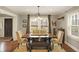 Elegant dining room featuring a rustic wooden table and ample natural light at 4517 Central Ave, Indianapolis, IN 46205