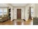 Warm entryway featuring hardwood floors and a decorative wood front door at 4517 Central Ave, Indianapolis, IN 46205