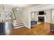 Hallway with staircase leading to living room featuring fireplace and hardwood floors at 4517 Central Ave, Indianapolis, IN 46205