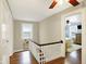 Hallway with wood floors leading to a bedroom with ceiling fan at 4517 Central Ave, Indianapolis, IN 46205