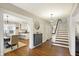 Bright hallway with hardwood floors, staircase, and doorway to an eat-in kitchen at 4517 Central Ave, Indianapolis, IN 46205