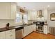Bright kitchen with stainless steel appliances, plenty of cabinets, and hardwood floors at 4517 Central Ave, Indianapolis, IN 46205