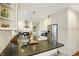 Modern kitchen featuring stainless steel appliances, white cabinets, and breakfast bar seating at 4517 Central Ave, Indianapolis, IN 46205
