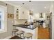 Modern kitchen with breakfast bar, stainless steel appliances, and white subway tile backsplash at 4517 Central Ave, Indianapolis, IN 46205