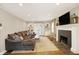 Cozy living room boasts hardwood floors, a fireplace, and built-in shelving at 4517 Central Ave, Indianapolis, IN 46205