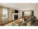 Spacious living room featuring a fireplace, large sofa, and windows for natural light at 4517 Central Ave, Indianapolis, IN 46205