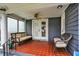 Inviting covered porch with a ceiling fan, seating, and tile flooring, perfect for relaxing outdoors at 4517 Central Ave, Indianapolis, IN 46205