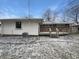 Backyard with a wooden deck, a partially fenced yard, and mature trees at 4721 N Longworth Ave, Indianapolis, IN 46226