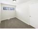 Cozy bedroom with neutral carpet, white walls, and ample natural light from the window at 4721 N Longworth Ave, Indianapolis, IN 46226