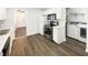 Well-equipped kitchen with white cabinetry, stainless steel appliances, and convenient laundry area at 4721 N Longworth Ave, Indianapolis, IN 46226