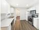 Well-lit kitchen with white cabinets, stainless steel appliances, and modern countertops at 4721 N Longworth Ave, Indianapolis, IN 46226