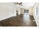 Inviting living area features wood floors, a ceiling fan, and sliding door access to the backyard at 4721 N Longworth Ave, Indianapolis, IN 46226