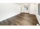 Spacious living room with wood floors, a ceiling fan, and abundant natural light at 4721 N Longworth Ave, Indianapolis, IN 46226