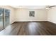 Spacious living room featuring wood flooring, neutral walls, and sliding glass doors to the outdoor deck at 4721 N Longworth Ave, Indianapolis, IN 46226