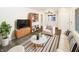 Bright living room featuring hardwood floors, stylish furniture, and ample natural light at 4721 N Longworth Ave, Indianapolis, IN 46226