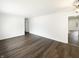 Open floorplan living room with wood floors, ample lighting, and a view into other rooms at 4721 N Longworth Ave, Indianapolis, IN 46226