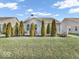 Backyard featuring a meticulously manicured lawn and privacy trees that enhance the serene outdoor space at 5003 Lilium Dr, Plainfield, IN 46168