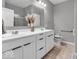 Bright bathroom featuring double sink vanity, large mirror, and ceramic tile flooring at 5003 Lilium Dr, Plainfield, IN 46168