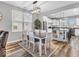 Dining area with modern lighting fixture and view into the updated kitchen at 5003 Lilium Dr, Plainfield, IN 46168
