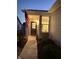 Inviting front porch with a covered entrance, American flag, and manicured bushes leading to the door at 5003 Lilium Dr, Plainfield, IN 46168
